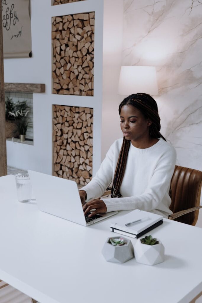 Woman in White Long Sleeve Shirt Sitting on Chair